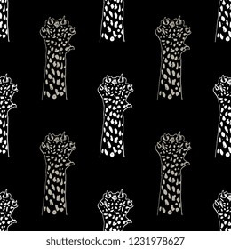 Seamless geometrical monochrome pattern with hand drawn silhouetted paws of cheetah or jaguar.
