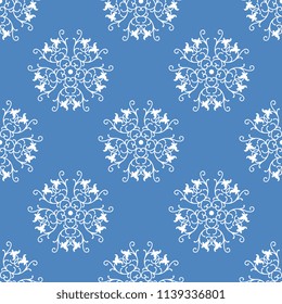 Seamless geometrical pattern with round abstract mandalas with floral motifs. White silhouettes on blue background.