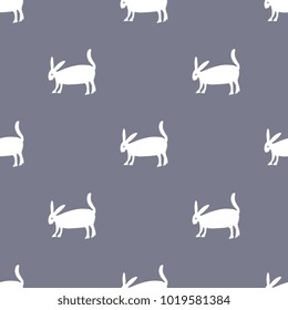 Seamless geometrical polka dot pattern with silhouettes of hare or rabbit.