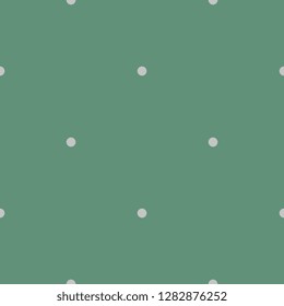 Seamless geometrical simple polka dot pattern. Small light green circles on green background. Traditional vintage style.