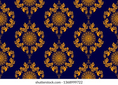 Seamless gold wallpaper pattern in vintage style. Seamless gold ornament on blue background. Floral ornament on background.  Seamless pattern for your design. Textile pattern. Wallpaper pattern