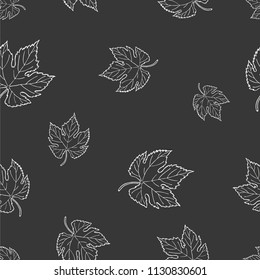 Seamless graphic design with hand drawn leaves. Fashion, interior, wrapping, packaging suitable. Repeat pattern of black and white maple leaf isolated on black