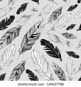 Seamless graphic pattern of feathers on a gray background 