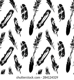 Seamless graphic pattern of feathers on a white background. Black and white abstract in watercolor style.