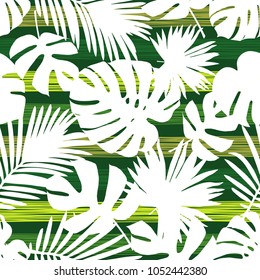 Seamless green background with decorative white leaves. Pattern with Palm leaves. Scribble texture. Textile rapport.