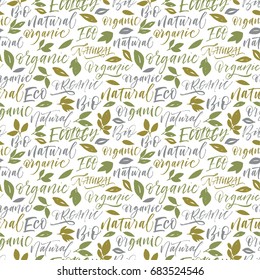 Seamless green eco pattern. Set of eco phrases : ecology, natural, bio, eco, organic. Leaves ornament. Ink illustration. Hand drawn ornament for wrapping paper.