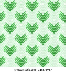 Seamless green pattern with knitted hearts