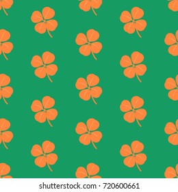 Seamless green pattern with orange clover leaves in Irish national flag colors - Eps10 vector graphics and illustration