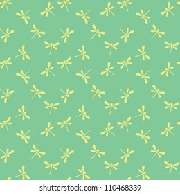 Seamless green pattern with yellow silhouette dragonflies