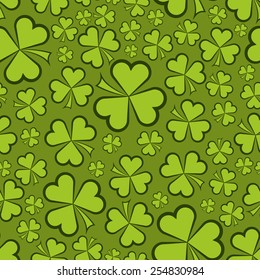 Seamless green shamrock shapes vector background.