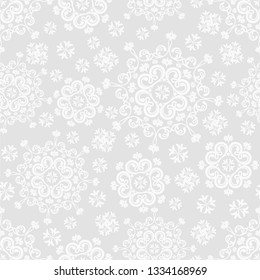 Seamless grey background with white mandala ornament in the east style. Ideal for printing on fabric or paper for wallpapers, textile, wrapping. Vector illustration.