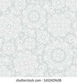 Seamless grey background with white mandala ornament in the east style. Ideal for printing on fabric or paper for textile, wrapping. Vector illustration.