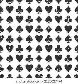 Seamless grunge pattern with card suits - hearts, clubs, spades and diamonds. Scratched Casino gambling, poker background. Alice in wonderland ornament.