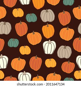 Seamless halloween pattern abstract. brown background. colored pumpkins. vector texture . fashionable print for textiles and wallpaper.