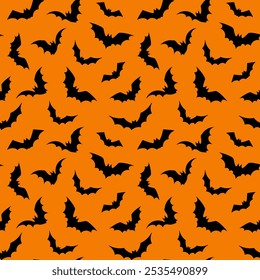 Seamless Halloween pattern with bat silhouettes on orange background