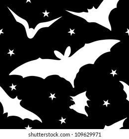 Seamless halloween pattern with white bats on black background