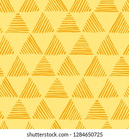 Seamless hand drawn geometric pattern with striped triangles in yellow colors