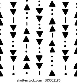 Seamless hand drawn geometric tribal pattern with triangles and dots. Vector navajo design.