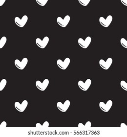 Seamless hand drawn heart shape pattern on black background