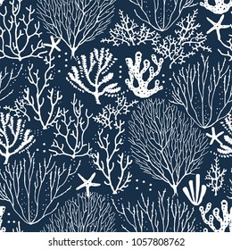 Seamless hand drawn pattern with coral reef and starfishes. Vector white illustration on dark blue background.