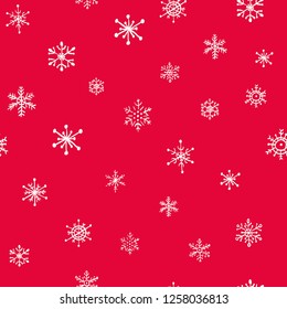 Seamless hand drawn snowflakes pattern on red background. Vector Illustration.