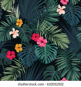 Seamless hand drawn tropical vector pattern with hibiscus flowers and exotic palm leaves on dark background.