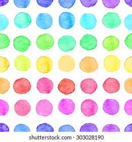Seamless hand drawn watercolor pattern made of round rainbow dots, isolated over white.