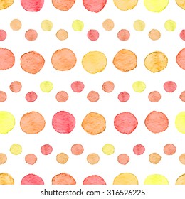 Seamless hand drawn watercolor pattern made of round red, orange and yellow dots, isolated over white.