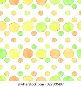 Seamless hand drawn watercolor pattern made of round green, yellow and orange dots, isolated over white.