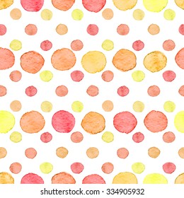 Seamless hand drawn watercolor pattern made of round red, orange and yellow dots, isolated over white.