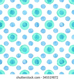 Seamless hand drawn watercolor pattern made of round various blue dots, isolated over white.
