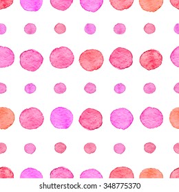 Seamless hand drawn watercolor pattern made of round red and pink dots, isolated over white.