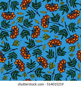 Seamless hand drown pattern. Clusters of mountain ash and autumn leaves on a blue background.