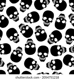 Seamless human skull background. Silhouettes of black skulls on a white background. Vector illustration for design and web.