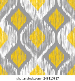 Seamless ikat pattern in yellow and grey colors. Vector tribal background