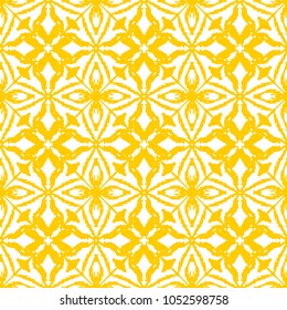 Seamless ikat pattern in yellow and white colors. Vector tribal background. Ethnic print for wallpaper, textile, clothing, web, scrapbooking design