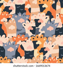 Seamless isolated vector pattern of different cartoon colored cat paws.