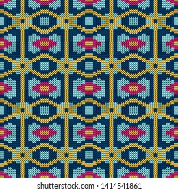 Seamless knitted ornate vector pattern in blue hues and pink, yellow colors as a fabric texture