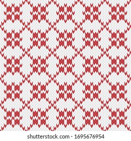 Seamless knitted pattern. Geometric ornament of crosses and lines in red and white colors. Christmas textile pattern