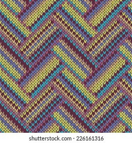Seamless knitted pattern. Multicolored repeating tribal template