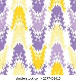 Seamless knitting vector pattern as a fabric texture mainly in red, blue and violet hues Fashionable seamless knitted pattern. Repeatable background.