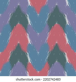 Seamless knitting vector pattern as a fabric texture mainly in red, blue and violet hues Fashionable seamless knitted pattern. Repeatable background.