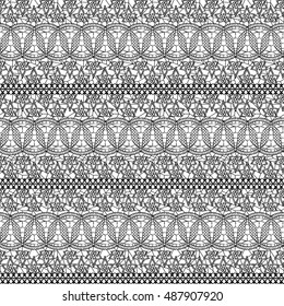 Seamless lacy texture. Black lace small flowers on a white background. Vector illustration