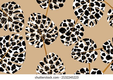 Seamless leaves with leopard pattern on beige. Vector Illustration.