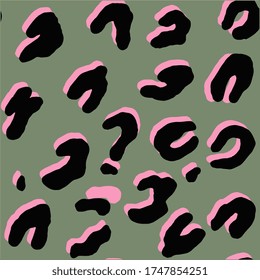 Seamless leopard print. Exotic pattern on a green background.