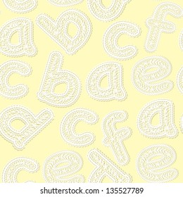 seamless light yellow background with letters made ??of white lace