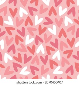 Seamless love pattern with hearts. Red, pink, white hearts on a pink background. Vector illustration for printing on fabric, wallpaper, wrapping paper.