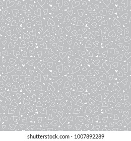 Seamless monochrome pattern with small hearts. Doodle chalk drawing texture on gray background. Cute vector surface pattern design for valentine's day, fabric print,wallpaper,wrapping paper, scrapbook