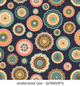 Seamless multicoloured pattern of retro flowers on a dark blue background. 