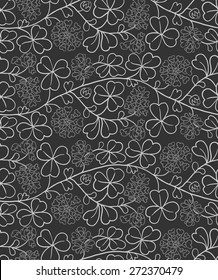 Seamless natural pattern with flowers and leaves. Black and white background with clover